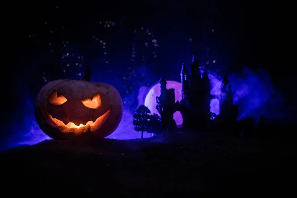 Horror view of Halloween pumpkin with scary smiling face. Head jack lantern with spooky building — Stock Photo, Image