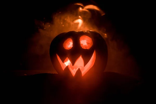 Sorriso de abóbora de Halloween e olhos raspados para noite de festa. Close-up vista de assustador Halloween abóbora com olhos brilhando dentro de fundo preto . — Fotografia de Stock