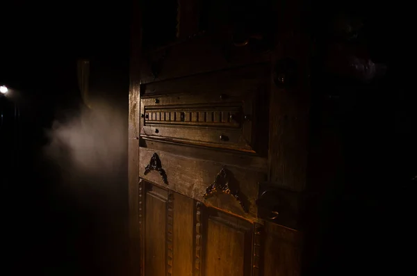 Close up view of old antique wooden door inside dark room. Selective focus — Stock Photo, Image