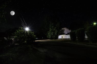 Gece oldukça köy üzerinde dolunay. Işıklar ile eski şehir caddesi güzel gece manzara. Rusya