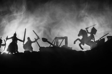 Medieval battle scene with cavalry and infantry. Silhouettes of figures as separate objects, fight between warriors on dark toned foggy background with medieval castle. clipart