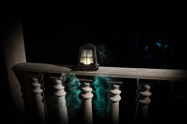 Retro style lantern at night. Beautiful colorful illuminated lamp at the balcony in the garden. — Stock Photo, Image