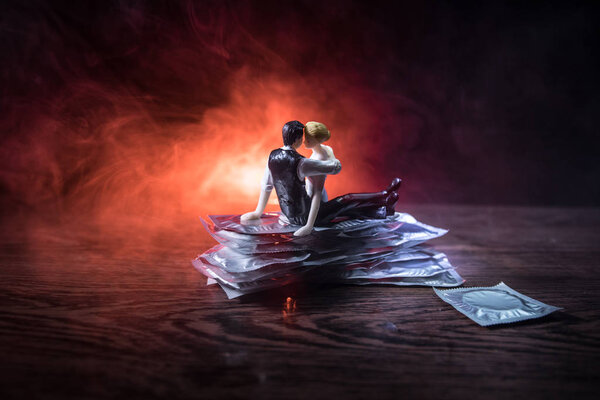 Close up of a young beautiful girl holding an open female condom, safe sex concept. Protection against AIDS and birth control