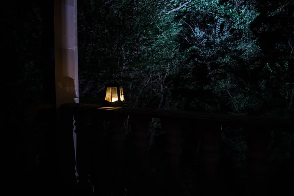 Retro style lantern at night. Beautiful colorful illuminated lamp at the balcony in the garden. — Stock Photo, Image