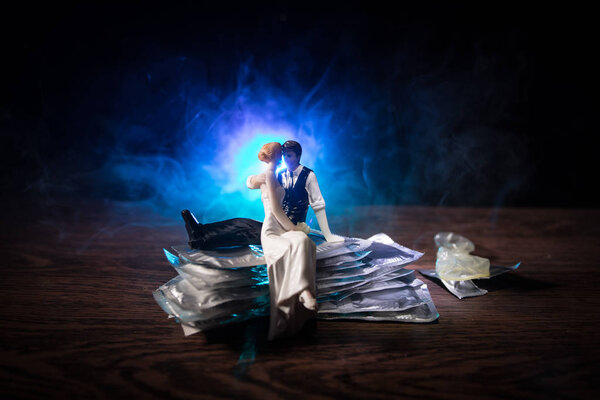 Close up of a young beautiful girl holding an open female condom, safe sex concept. Protection against AIDS and birth control