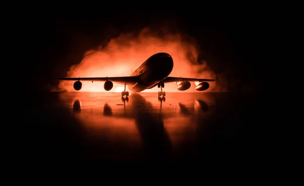 Artwork decoration. White passenger plane ready to taking off from airport runway. Silhouette of Aircraft during night time.