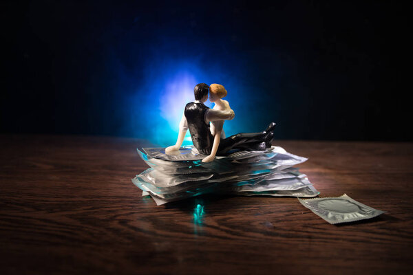 Close up of a young beautiful girl holding an open female condom, safe sex concept. Protection against AIDS and birth control