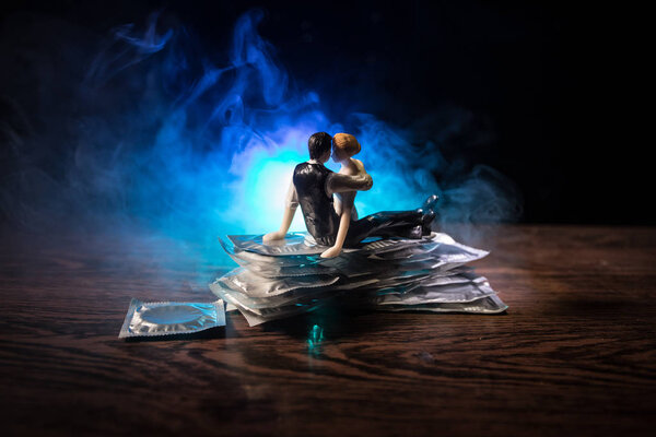 Close up of a young beautiful girl holding an open female condom, safe sex concept. Protection against AIDS and birth control