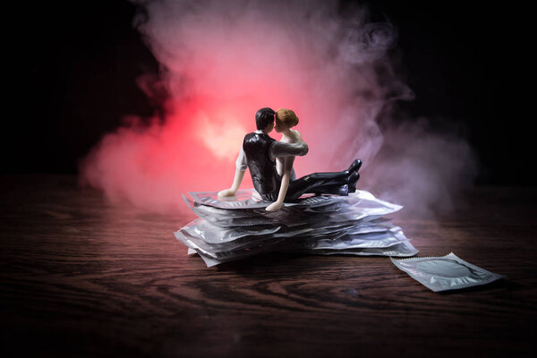 Close up of a young beautiful girl holding an open female condom, safe sex concept. Protection against AIDS and birth control