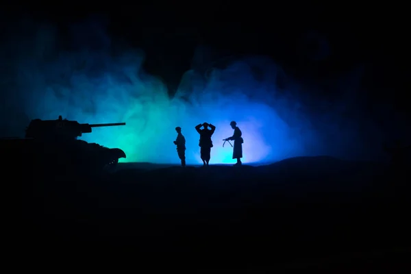 Battle scene. Military silhouettes fighting scene on war fog sky background. A German soldiers raised arms to surrender. Plastic toy soldiers with guns taking prisoner the enemy soldier. — Stock Photo, Image