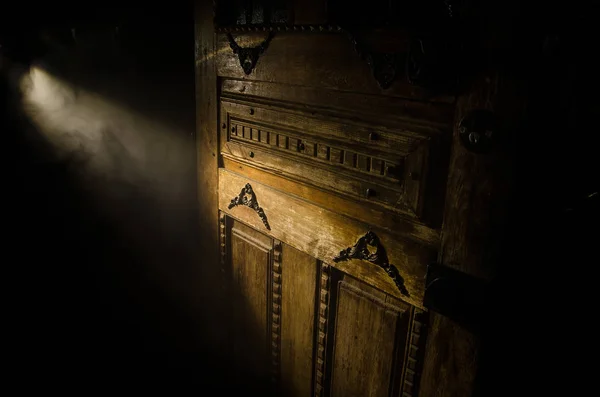 Close up view of old antique wooden door inside dark room. Selective focus — Stock Photo, Image