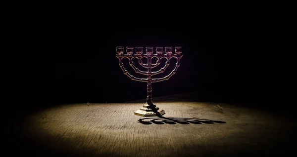 Low key image of jewish holiday Hanukkah background with menorah on dark toned foggy background — Stock Photo, Image