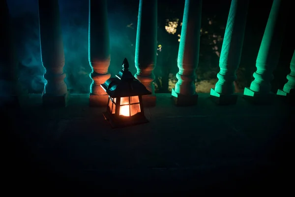 Retro style lantern at night. Beautiful colorful illuminated lamp at the balcony in the garden. — Stock Photo, Image