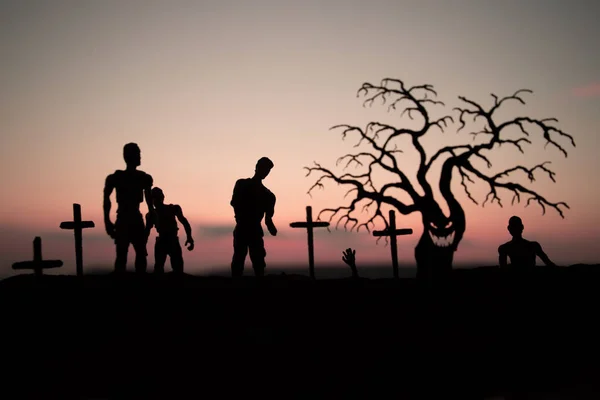 Silhouette some zombies on the cemetery walking around at sunset. Selective focus — Stock Photo, Image