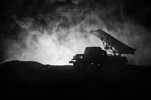 Rocket launch with fire clouds. Battle scene with rocket Missiles with Warhead Aimed at Gloomy Sky at night. Soviet rocket launcher on War Background.