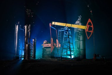 Artwork decoration. Oil pump and oil rig energy industrial machines for petroleum at night with fog and backlight. Oil refining factory. Energy industrial concept. Selective focus clipart