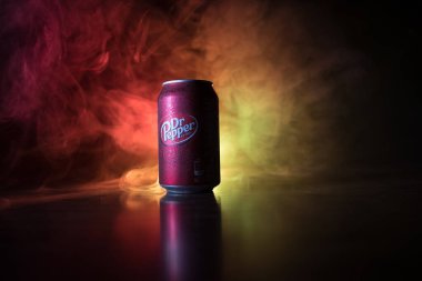 Bakü, Azerbaycan - 15 Eylül 2019: Koyu tonlu sisli arka planda ışıkla birlikte Dr Pepper'ın meşrubata bakması. Dr Pepper eşsiz bir lezzete sahip olarak pazarlanan bir meşrubat.