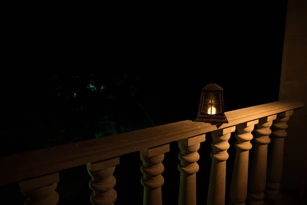 Retro style lantern at night. Beautiful colorful illuminated lamp at the balcony in the garden. — Stock Photo, Image