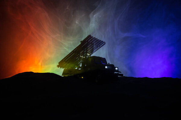 Rocket launch with fire clouds. Battle scene with rocket Missiles with Warhead Aimed at Gloomy Sky at night. Soviet rocket launcher on War Background.