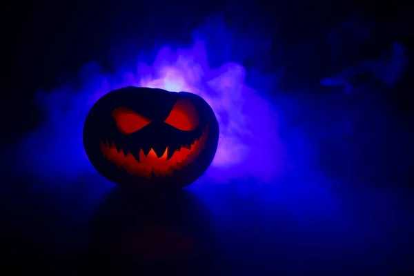 Halloween pumpkin smile and scary eyes for party night. Close up view of scary Halloween pumpkin with eyes glowing inside at black background — Stock Photo, Image
