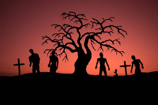 Silhouette några zombies på kyrkogården gå runt vid solnedgången. Selektivt fokus — Stockfoto