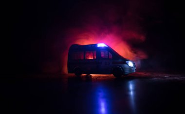 Ambulans arabasıyla Corona virüsü konsepti. Corona virüsünü önlemek için tedbir amaçlı önlemler için evde kal. Ambülans arabası koyu sisli arka planda. Yaratıcı sanat dekorasyonu. Seçici odak