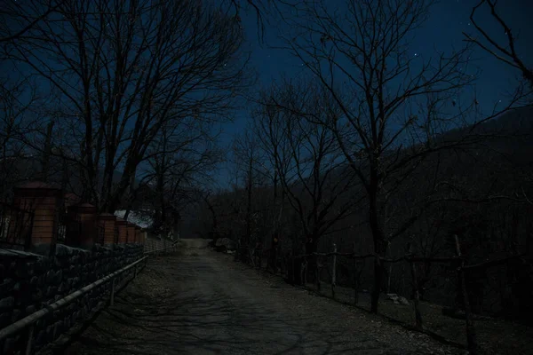 Full moon over quiet village at night. Beautiful night landscape of mountain village under the moonlight. Azerbaijan nature. Long exposure shot