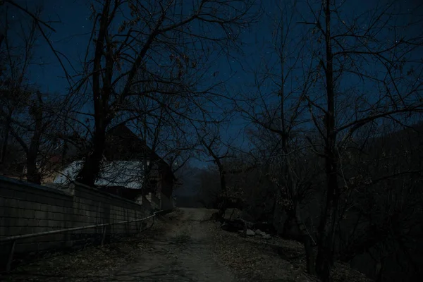 Full moon over quiet village at night. Beautiful night landscape of mountain village under the moonlight. Azerbaijan nature. Long exposure shot