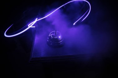 Ahşap masadaki servis zilini arıyorum. Arka planda tonlu ışıklar var. Otel resepsiyon zili, servis zili masada, seçici odak