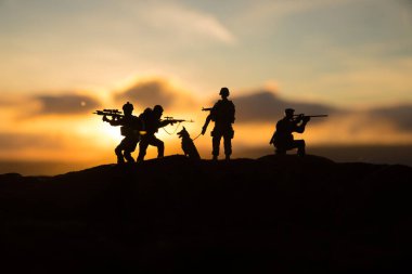 War Concept. Military silhouettes fighting scene on war fog sky background, World War Soldiers Silhouette Below Cloudy Skyline sunset. Selective focus clipart