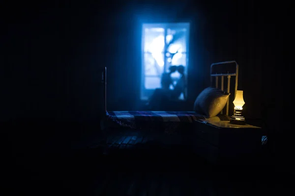 A realistic dollhouse bedroom with furniture and window at night. Romantic couple sitting on window. Man and woman making love in bedroom. Artwork table decoration . Selective focus.