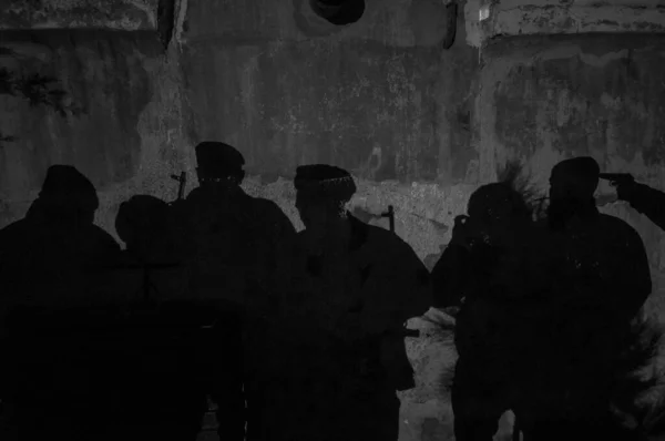 Shadow of soldiers on wall at night. Army concept. Fighting silhouettes on colored stone wall. Selective focus
