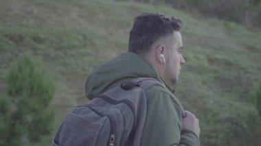 Yalnız bir adam cüzdanı sırt çantasından düşen boş bir caddede yürüyor.