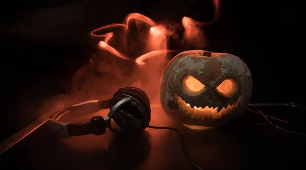 Halloween Kürbis Auf Einem Tisch Mit Kopfhörern Auf Dunklem Hintergrund — Stockfoto