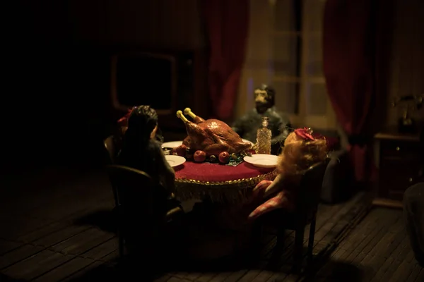 Thanksgiving holiday creative concept. A realistic dollhouse living room with furniture and window at night. Thanksgiving Turkey miniature on table. Selective focus
