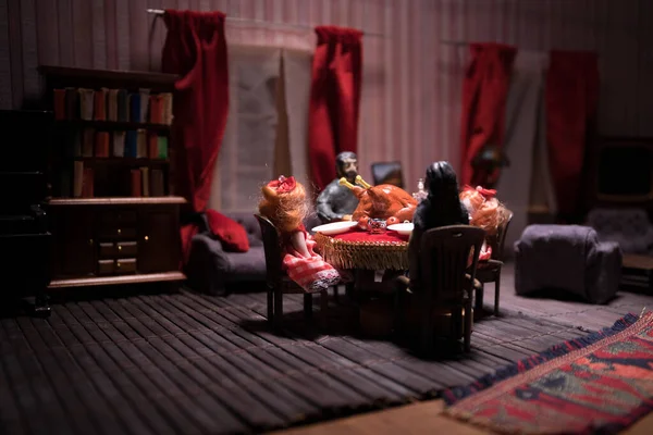 Thanksgiving holiday creative concept. A realistic dollhouse living room with furniture and window at night. Thanksgiving Turkey miniature on table. Selective focus