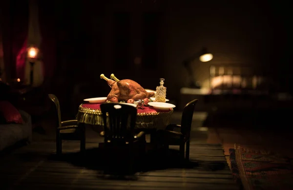 Thanksgiving holiday creative concept. A realistic dollhouse living room with furniture and window at night. Thanksgiving Turkey miniature on table. Selective focus