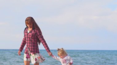 Anne ve kızı deniz kenarında.