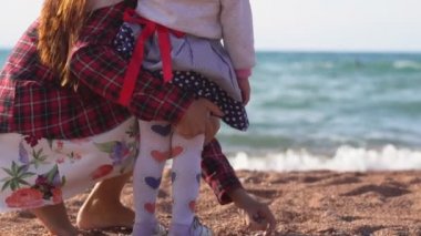 Anne ve kızı deniz kenarında.