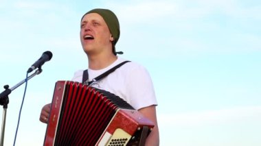 Müzisyen akordeon çalar.