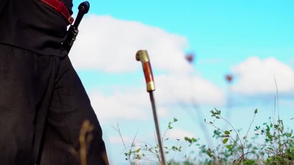 The hilt of a sword stuck in the ground — Stock Video