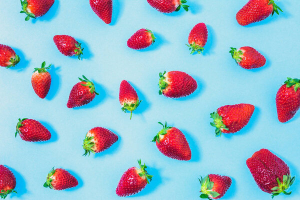 Fresh strawberry, pattern with fruits, natural texture with fruit on blue background