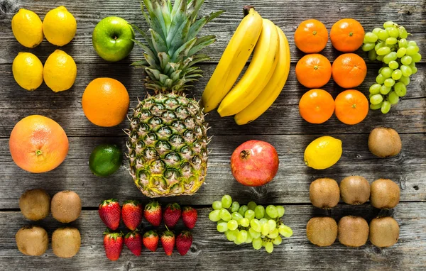 Farm table with fruits, flat lay. Fresh fruit background, healthy food and clean eating concept.