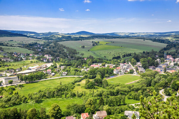 Landscape of town in the valley, green scenery and blue sky, Sudety in Poland