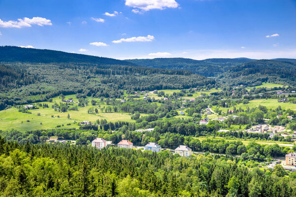 Aerial view of rural landscape in mountain valley, town and houses in nature