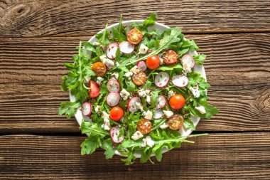 İştah açıcı sebze salatası, taze gıda üzerine plaka üzerinde ahşap arka plan, sağlıklı beslenme kavramı