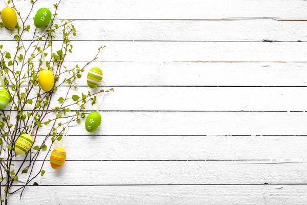 Happy easter egg with pattern. Colored eggs on white wooden background.
