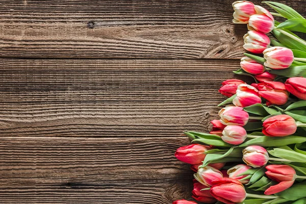 International women day background with tulips, spring easter card with flowers bouquet on wooden boards