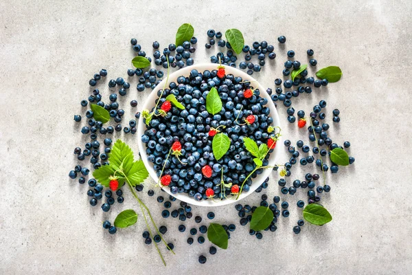 Bowl with blueberries. Fresh blue berry and wild strawberry, fruit mix.