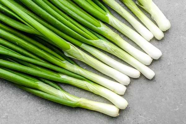 Cebolletas frescas con cebolleta verde sobre fondo gris —  Fotos de Stock